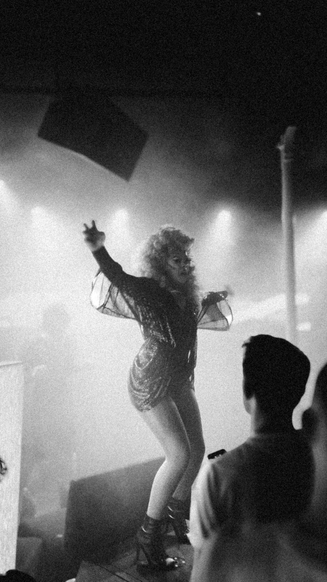 Performer on a foggy club stage